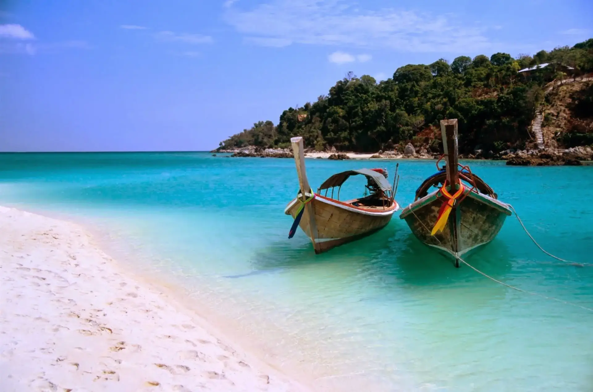 Wooden boats pulled up on a white beach in Zanzibar
